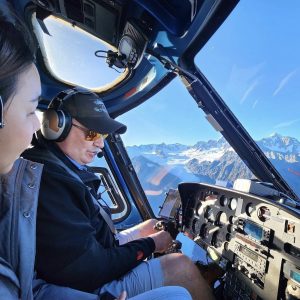 Megan McCarthy standing beside a blue helicopter.