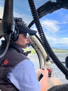 Rachel Button standing by helicopter